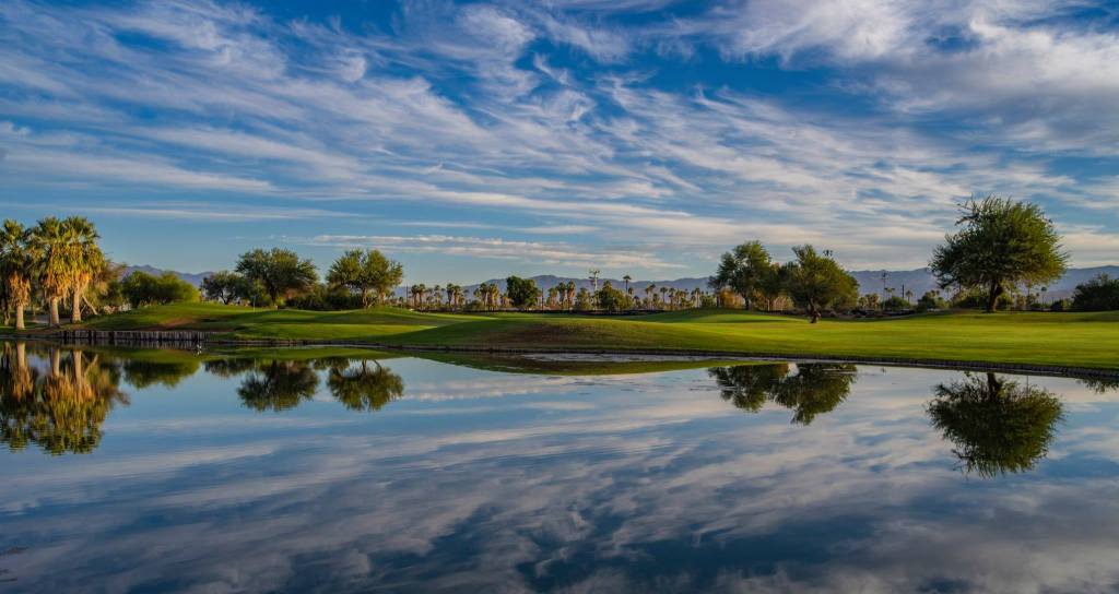Golf course beneath blue sky